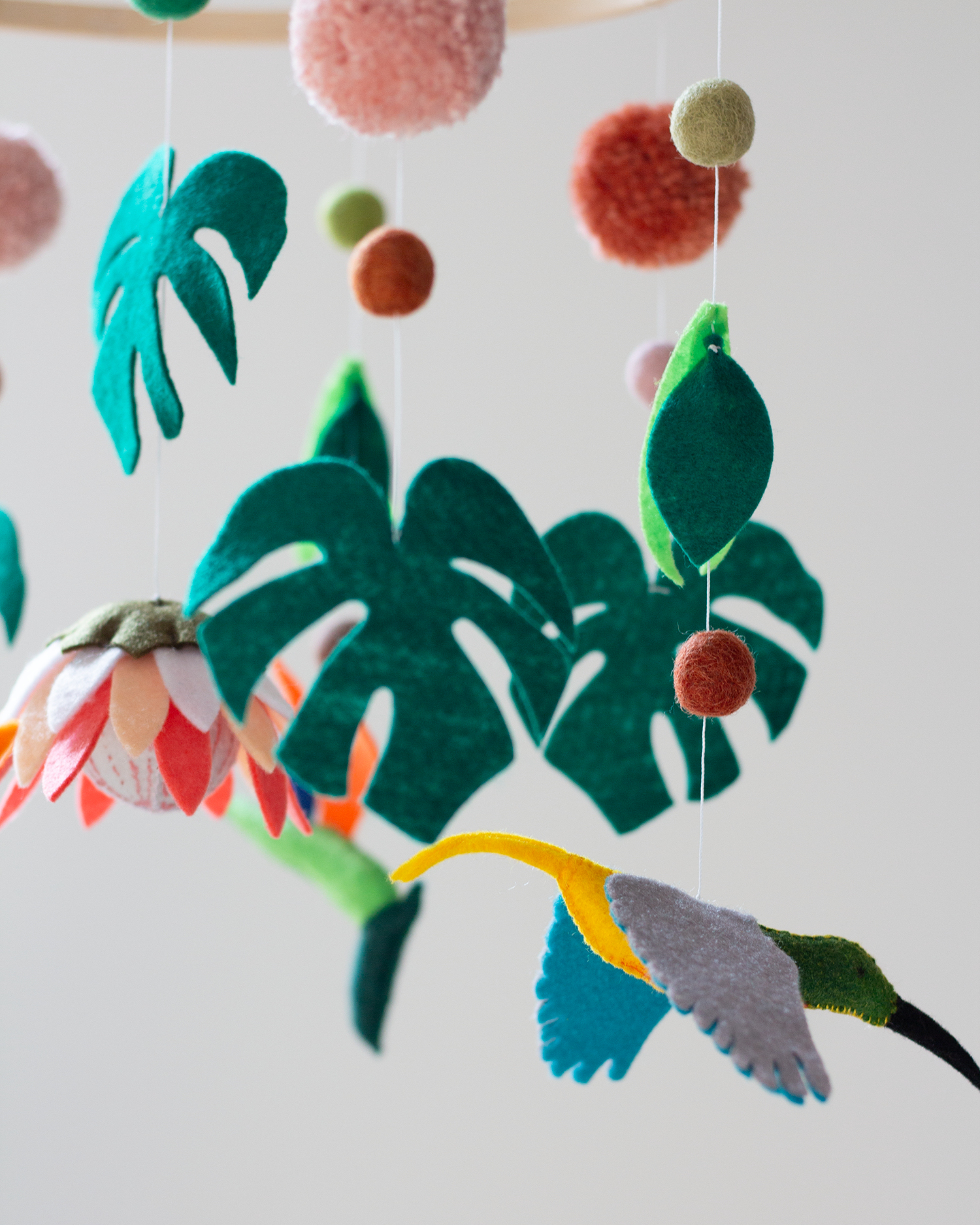Close-up of handcrafted African wildlife animals and foliage on the Big Five Classic Hoop Mobile.
