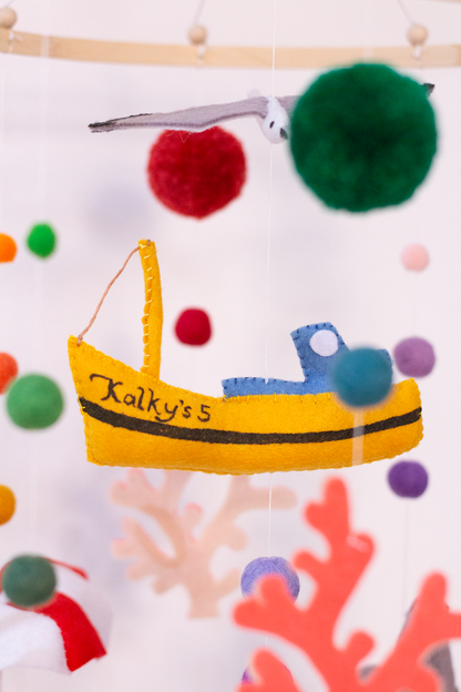 Close-up of the handcrafted felt fishing boat and stitched felt details on the Kalk Bay mobile