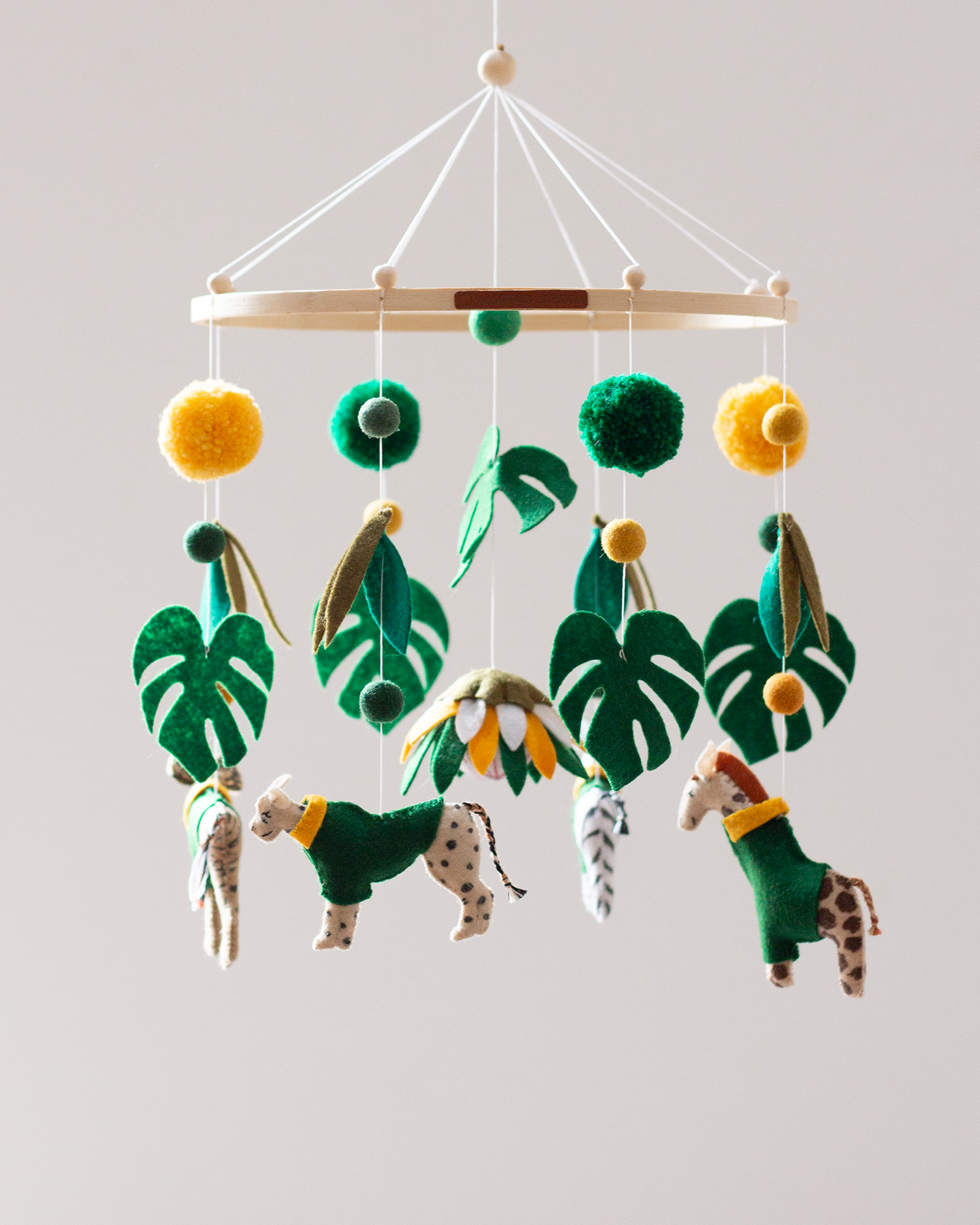 Handcrafted felt African animals wearing green and gold supporters jerseys