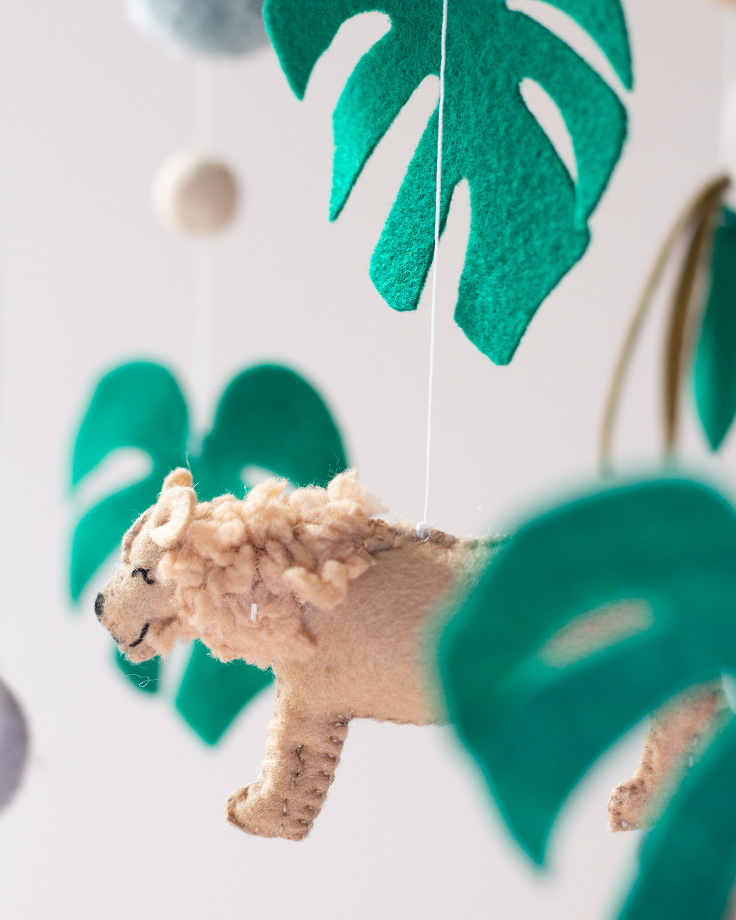 Close-up of handcrafted African wildlife animals and foliage on the Big Five Classic Hoop Mobile.