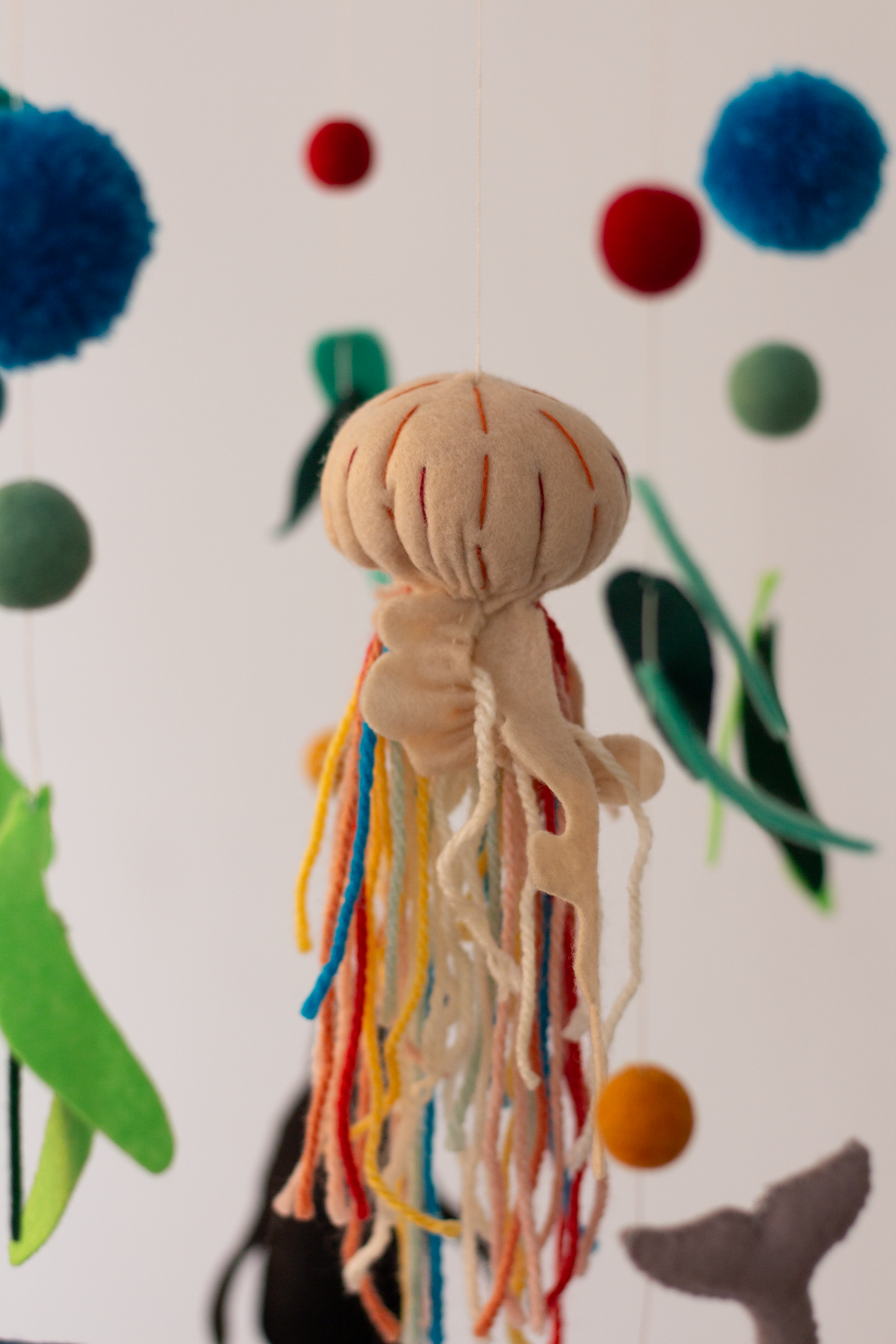 Decorative marine life hanging mobile with jellyfish and coral accents
