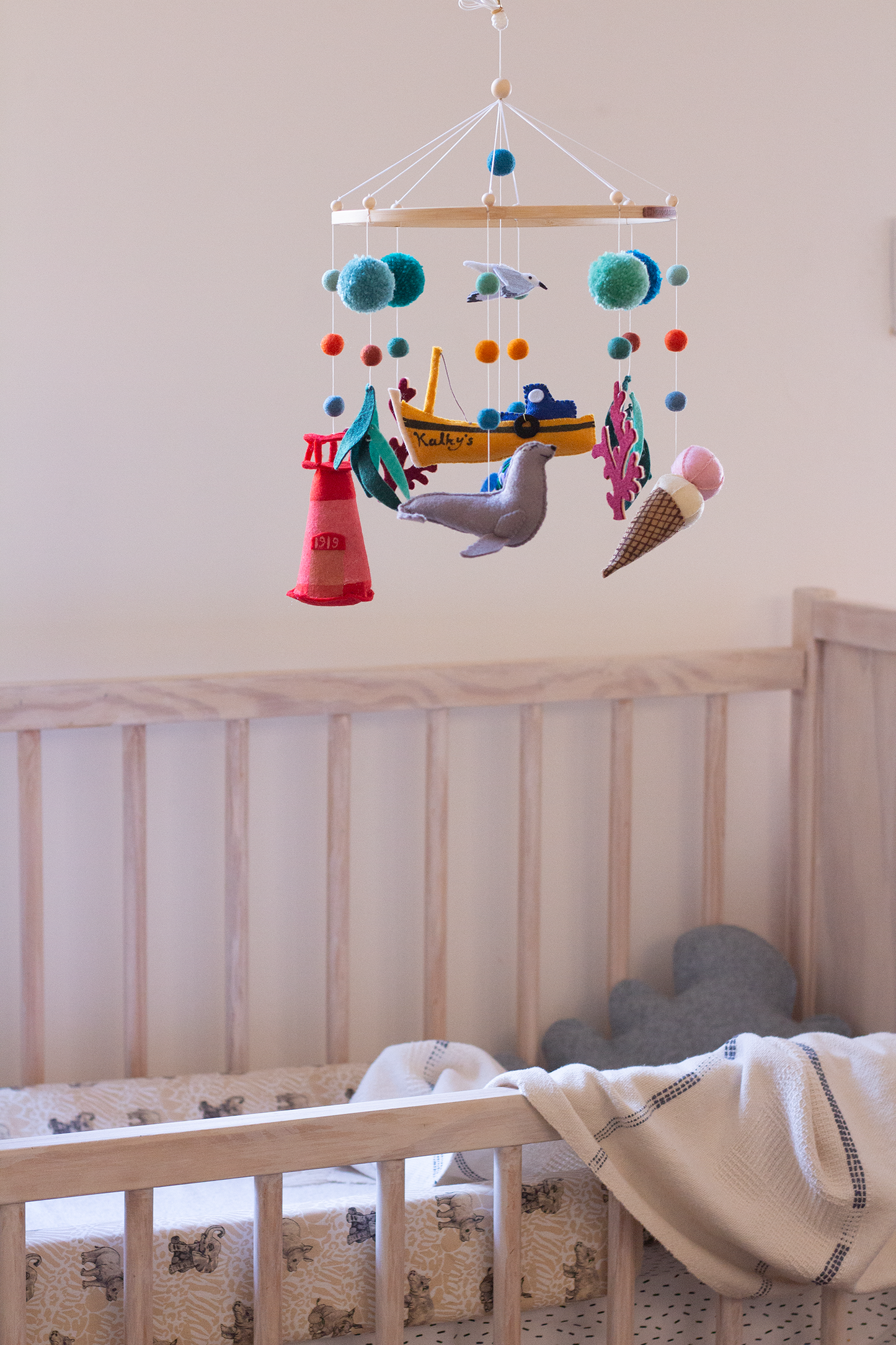 Handcrafted Kalk Bay mobile with fishing boat, seagull and coastal-inspired felt decorations in nursery