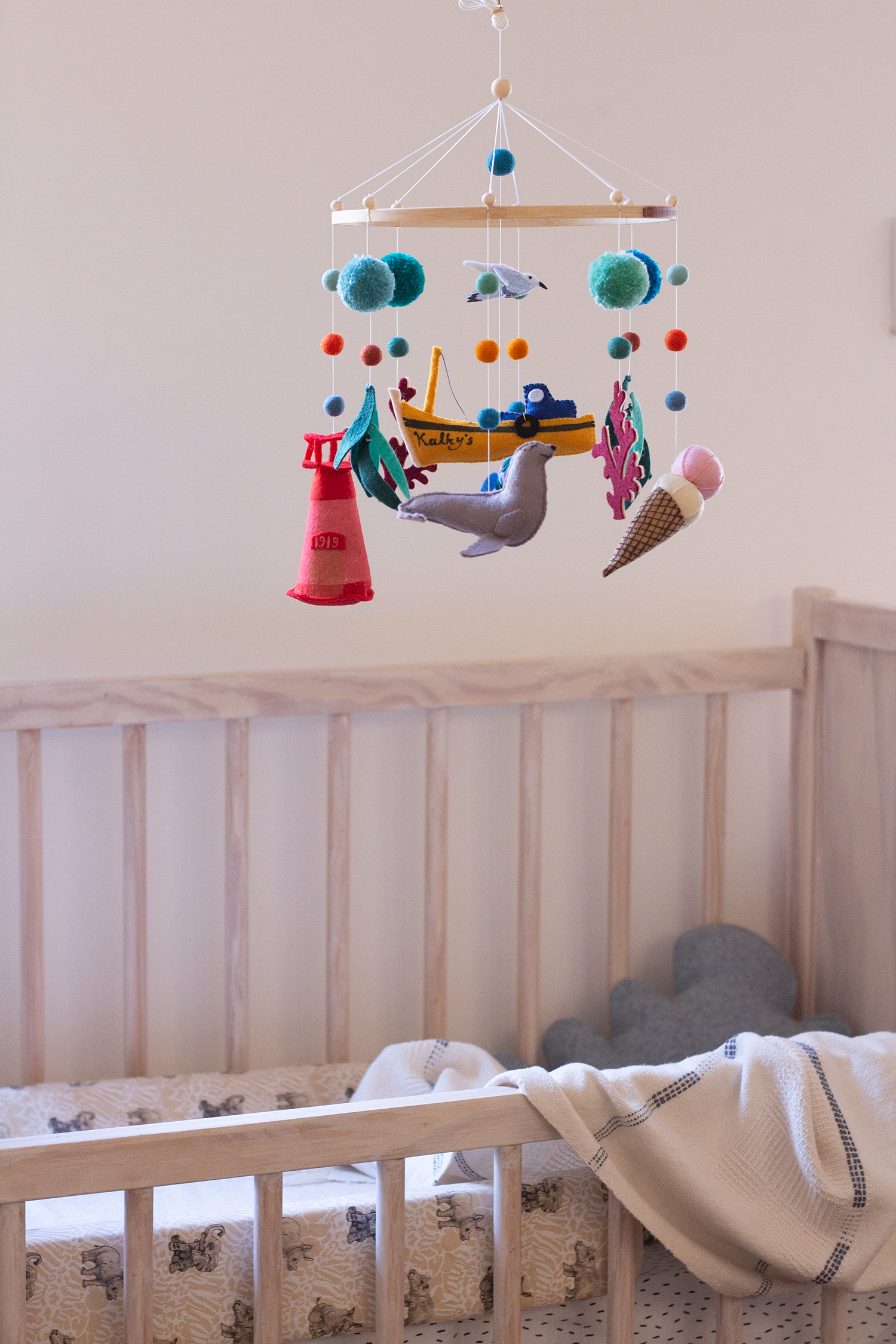 Handcrafted Kalk Bay mobile with fishing boat, seagull and coastal-inspired felt decorations in nursery