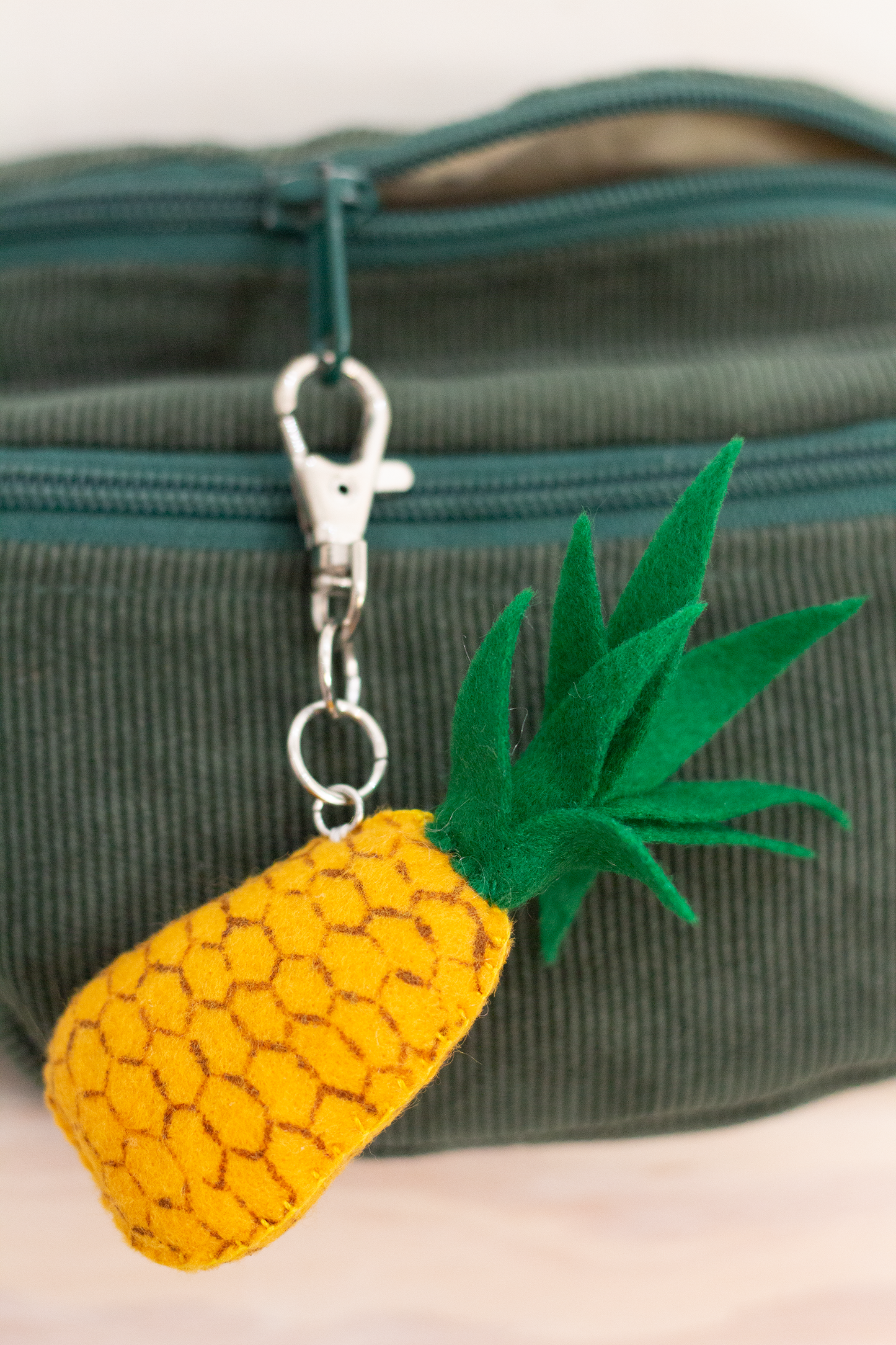 Decorative felt bag charm with swivel hook and pineapple